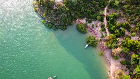 Scenic-Coast-Of-Kenya-With-Lush-Vegetation-And-Boats-On-The-Turquoise-Water---aerial-top-down