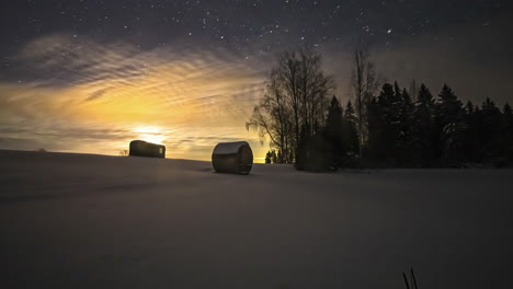 Amazing-timelapse-of-starry-night-with-highlighted-full-moon-light-in-a-ice-covered-wide-land-with-forest-and-container-cabin-house-in-Lithuania
