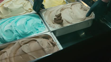 Putting-a-chocolate-gelato-ice-cream-tray-in-a-showcase