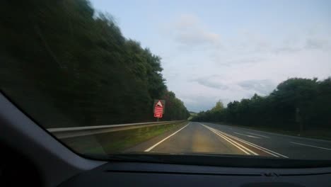 Timelapse-Car-POV-on-British-Road-at-Sunset-with-Car-Headlights-and-Roadworks-Devon-UK-4K