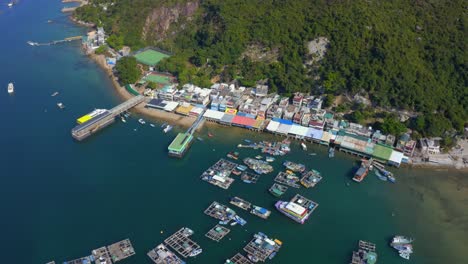 Drone-shot-orbiting-above-a-small-fisher-village-with-a-dock-and-oysters-farm-during-the-day-2