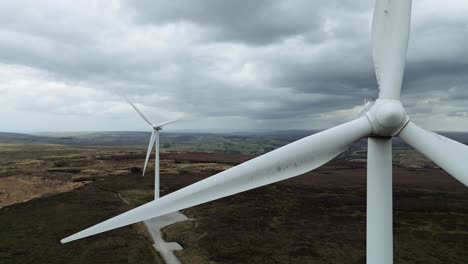 Close-up-drone-aerial-video-view-of-a-wind-farm-and-wind-turbines-turning-in-the-wind