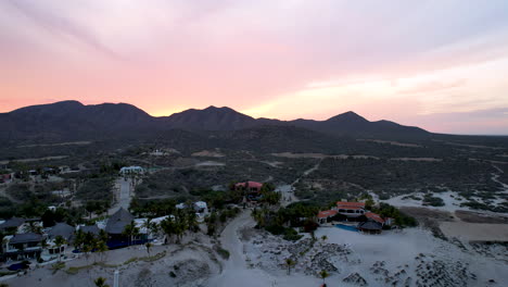 Rotational-drone-shot-of-the-exclusive-restaurants-on-the-beach-line-of-cabo-san-lucos