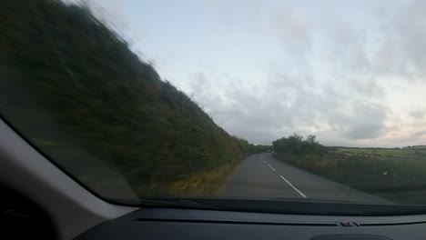 Timelapse-Car-POV-on-Countryside-Road-at-Sunset-with-Cars-Passing-and-Junctions-in-Devon-UK-4K