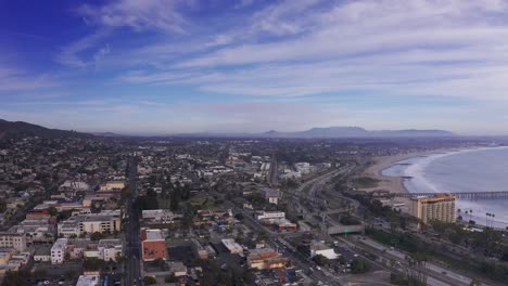 Dolly-panning-aerial-shot-of-downtown-Ventura,-California-along-the-coast