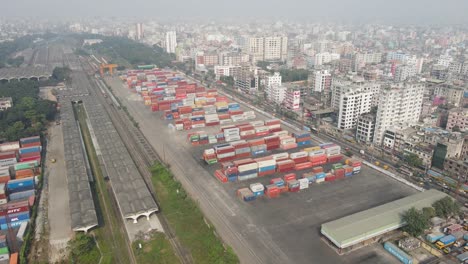 Aerial-ascending-view-ship-containers-terminal-near-railroad-station,-Dhaka