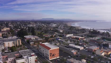 Aerial-wide-reverse-pullback-shot-of-downtown-Ventura,-California-along-the-coast