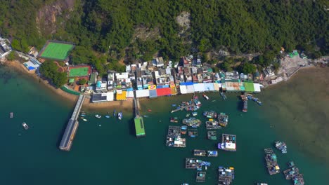 Drone-shot-orbiting-above-a-small-fisher-village-with-a-dock-and-oysters-farm-during-the-day-1