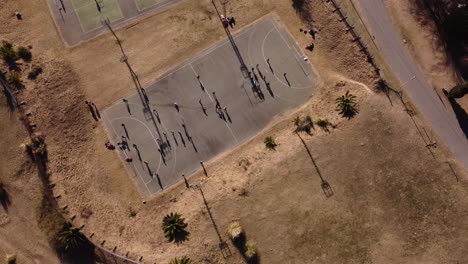 A-dynamic-aerial-shot-moving-above-the-handball-court-with-players-under-training