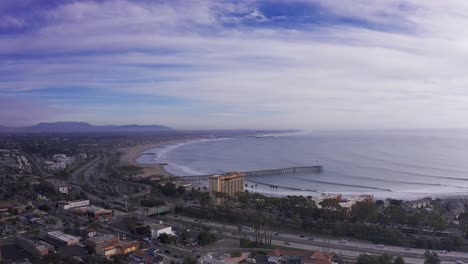 Wide-descending-aerial-shot-of-downtown-Ventura,-California-along-the-coast
