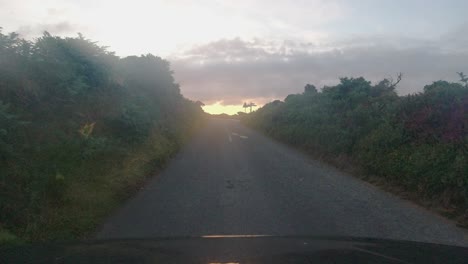 Sunset-POV-Car-Dashcam-Footage-on-Countryside-Road-with-Dramatic-Clouds-and-Sea-Background-Devon-UK-4K