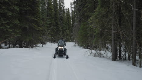 Snowmobiling-ride-through-the-forest-in-the-winter