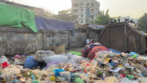 Establisher-view-of-pile-of-rubbish-bags-in-middle-of-street-in-Bangladesh