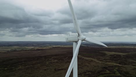 Close-up-drone-aerial-view-of-a-wind-farm-and-wind-turbines-turning-in-the-wind