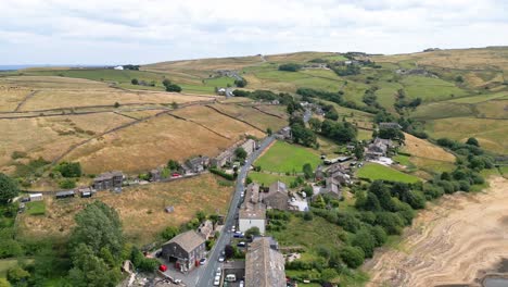 Aerial-footage-of-a-rural-industrial-Yorkshire-town-village-with-old-mill-and-chimney-stack