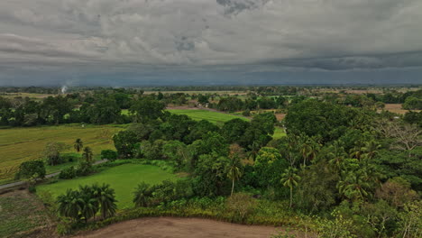 Guarumal-Panama-Aerial-v4-panoramic-view-circular-pan-shot-capturing-beautiful-lush-green-fertile-farmland-in-open-space-with-stormy-clouds-in-the-sky---Shot-with-Mavic-3-Cine---April-2022