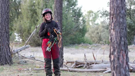 Woman-proudly-smiling-because-of-working-in-height-pruning-industry-while-untying-a-climbing-rope-for-height-pruning