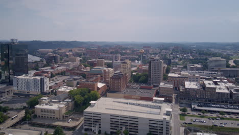 Wide-aerial-timelapse-hyperlapse-of-the-Sunsphere-in-downtown-Knoxville,-TN-in-the-afternoon-sun