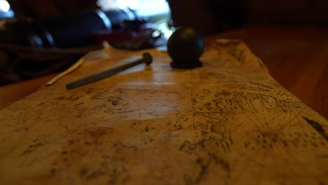 Close-up-of-old-map-map-with-cannon-balls-and-cannon-in-the-backdrop