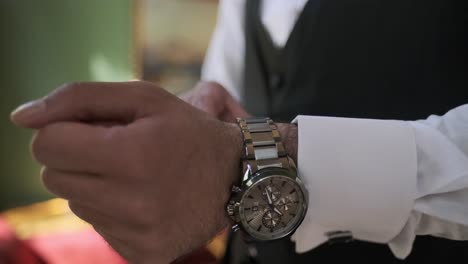 Businessman-dresses-and-someone-adjusts-his-watch,-preparing-for-a-meeting