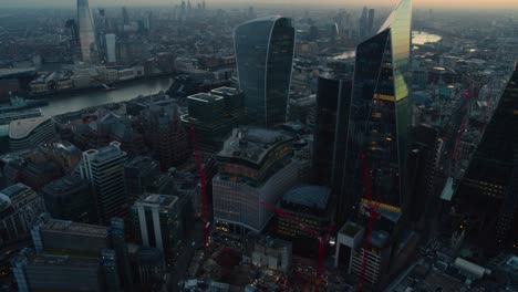 Early-evening-pan-up-aerial-of-the-central-London-Skyline-featuring-skyscrapers-and-the-Thames-river