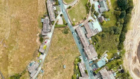 Aerial-footage-of-a-rural-industrial-town-village-with-old-mill-and-chimney-stack