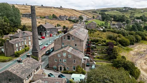 Aerial-drone-footage-of-a-rural-industrial-Yorkshire-Village-with-old-mill-chimney
