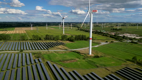 Windturbines-are-spinning-in-a-solar-farm-on-a-green-field