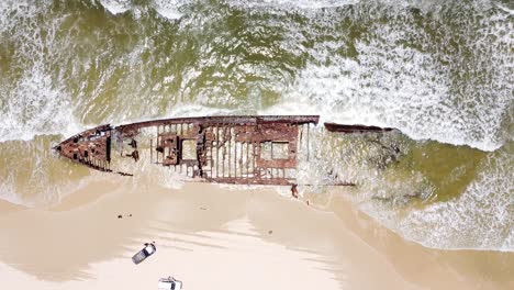 Drone-aerial-top-view-of-a-shipwreck-next-to-the-beach-in-Fraser-Island,-Australia