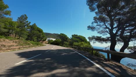 A-POV-shot-of-a-cyclist-cornering-and-descending-down-a-twisty-mountain-pass-at-high-speed,-Catalunya,-Spain