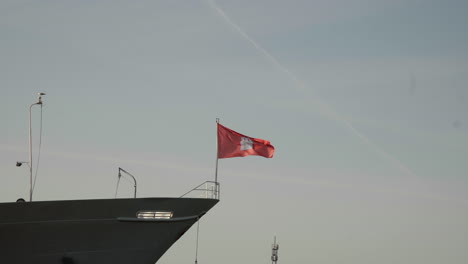 The-Flag-of-the-City-of-Hamburg-waving-in-the-wind-on-top-of-Cap-San-Diego-in-Hamburg-Harbor