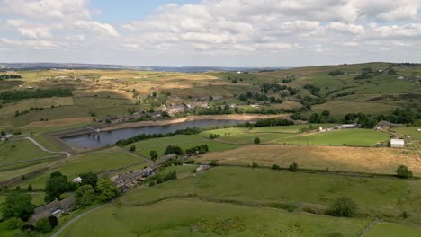 Aerial-drone-video,-footage-of-a-rural-Yorkshire-Village-with-a-mill-chimney