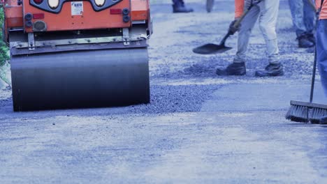 City-Workers-and-Small-Steamroller-Setting-Asphalt-on-Street