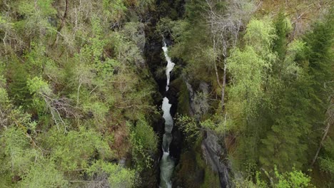 Top-down-aerial-looking-down-into-deep-gorge-ravine-Bordalsgjelet-in-Voss-Norway---Spectacular-tourist-attraction-seen-from-above