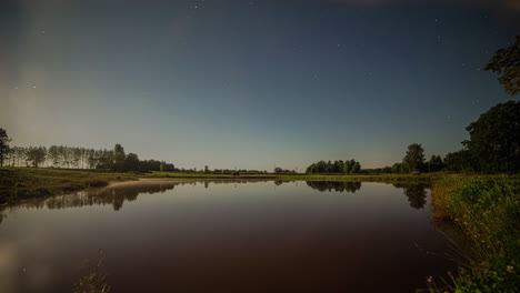 Time-lapse-shot-of-bright-shining-moon-lighting-on-natural-lake-in-nature