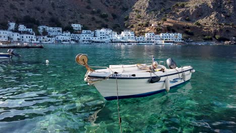 Small-Greek-boat-floating-on-the-translucent-waters-of-the-picturesque-port-of-Loutro