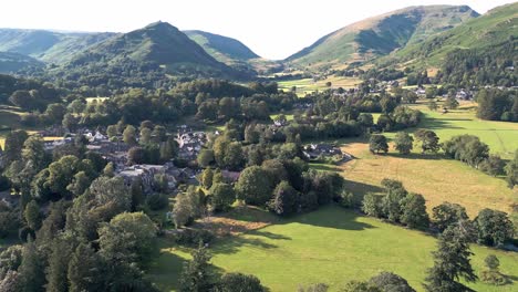 Aerial-video-footage-Grasmere-Village,-Town-in-the-Cumbrian-Lake-District-National-Park-England-UK-on-a-beautiful-sunny-day