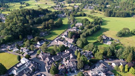 Aerial-video-footage-Grasmere-Village,-Town-in-the-Cumbrian-Lake-District-National-Park-England-UK-on-a-beautiful-sunny-evening
