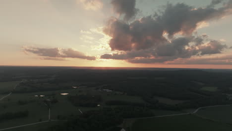 Aerial-view-of-beautiful-sunset-over-farmland-in-rural-Missouri,-USA