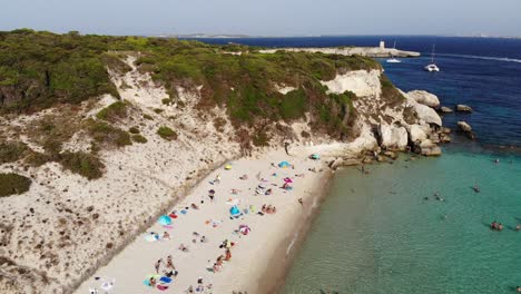 Drone-flies-backward-on-Grande-Sperone-beach-in-Corsica-island-during-a-sunny-afternoon