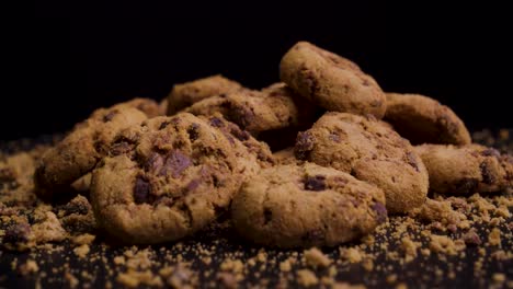 Close-up-of-vegan-or-vegetarian-cookies-spinning-in-front-of-a-black-background,-static-shot