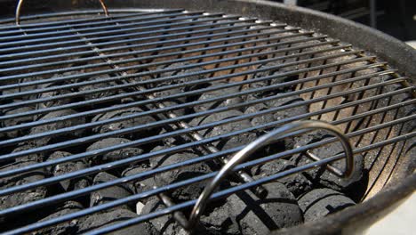 Slowmotion-shot-of-a-coal-barbecue-BBQ-with-the-grill-on