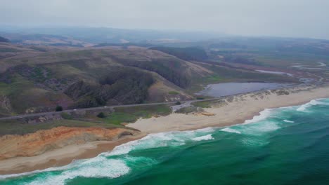 HIgh-Aerial-view-drone-shot-rotation-pan-of-California-coast-rock-cliffs-on-a-foggy-day