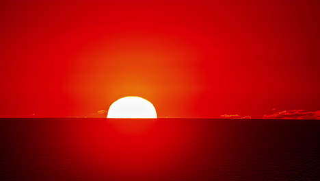 Time-lapse-of-big,-glowing-and-yellow-sun-setting-on-red-horizon
