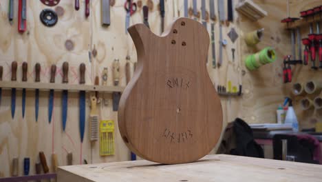 Luthier's-Workshop---Unfinished-Guitar-Body-made-off-African-Mahogany-Wood-on-Workbench---dolly-slide