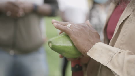 Slow-motion-footage-of-a-person's-hands-wiping-off-the-outside-of-a-cacao-fruit