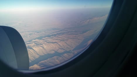 Aerial-view-from-the-window-seat-of-a-passenger-plane-onto-the-rugged-mountains-of-remote-Iran