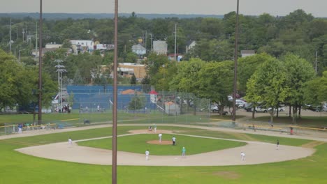 Two-Teams-Compete-On-Baseball-Field-During-Hot-Afternoon-In-Small-Town