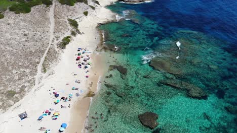 Drone-slowly-flies-over-the-small-Saint-Antoine-beach-in-Corsica