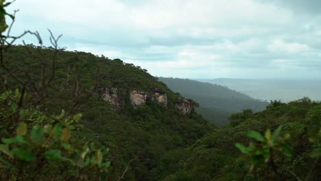 Tilting-up-4K-shot-of-rolling-hills-and-cliffs-in-a-tropical-rainforest-inside-of-the-famous-Chapada-Diamantina-National-Park-in-Northeastern-Brazil-on-an-overcast-rainy-day